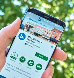 A person holding a smartphone displaying the 