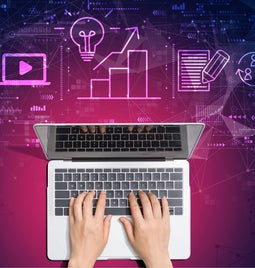 birds eye view of woman typing on laptop with purple graphics on top