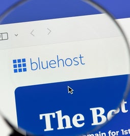 Magnifying glass hovering over the Bluehost logo on the desktop homepage