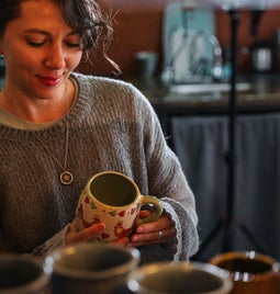 Woman admires custom mug in shop