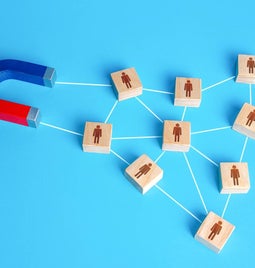 Photo of a magnet connected to counters featuring outlines of people