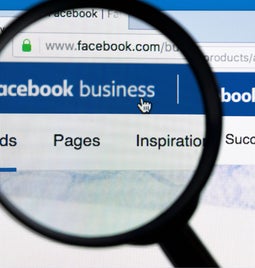 A magnifying glass positioned over a monitor with 