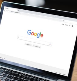 Laptop screen showing Google search homepage