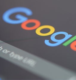 Tablet pen pointing at the Google search bar on the homepage