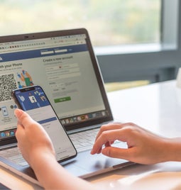 Facebook log in page on laptop and mobile