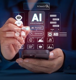 A person interacts with a smartphone displaying an interface for AI search, featuring icons for prompts, media, and coding.