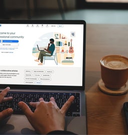 Hands typing on a laptop with LinkedIn on the screen