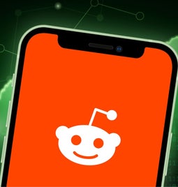 A phone with the reddit logo on screen