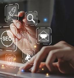 Hand pointing at floating SEO-related icons