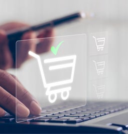 shopping cart icon over laptop