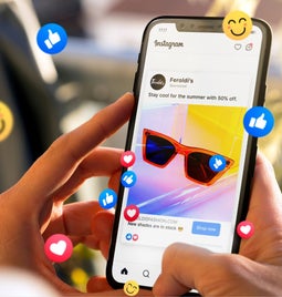 oman holding smartphone showing advertising example on Instagram