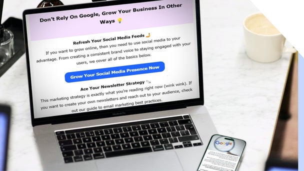 Laptop on table with a smartphone showing an email newsletter