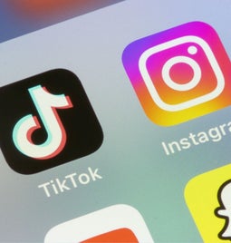 Photo of a phone closeup showing the icons for TikTok and Instagram