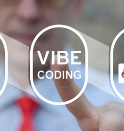 A blurred person in a blue shirt and red tie points at the words 