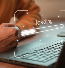 balled fist waiting by a laptop screen that says 