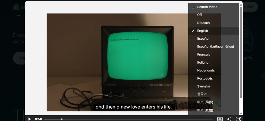 Screenshot of a video in widescreen on a website with subtitles and list of languages on screen